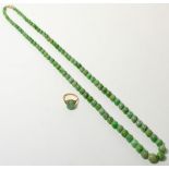 A jade necklace and a 9ct gold jade ring (2)Jade necklace - 61g gross. Jade ring - finger size N,