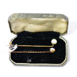 An opal stick pin and a pearl stick pin, unmarked yellow metalOpal stick pin - 1.35g gross. Pearl