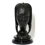 An African carved ebony female head, on black socle plinth base