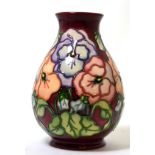A Moorcroft vase in the Pansy pattern by Barbara MontfordLightly crazed otherwise OK.