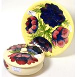 A Walter Moorcroft ''Anemone'' bowl and cover on a cream ground together with a similar plate (2)