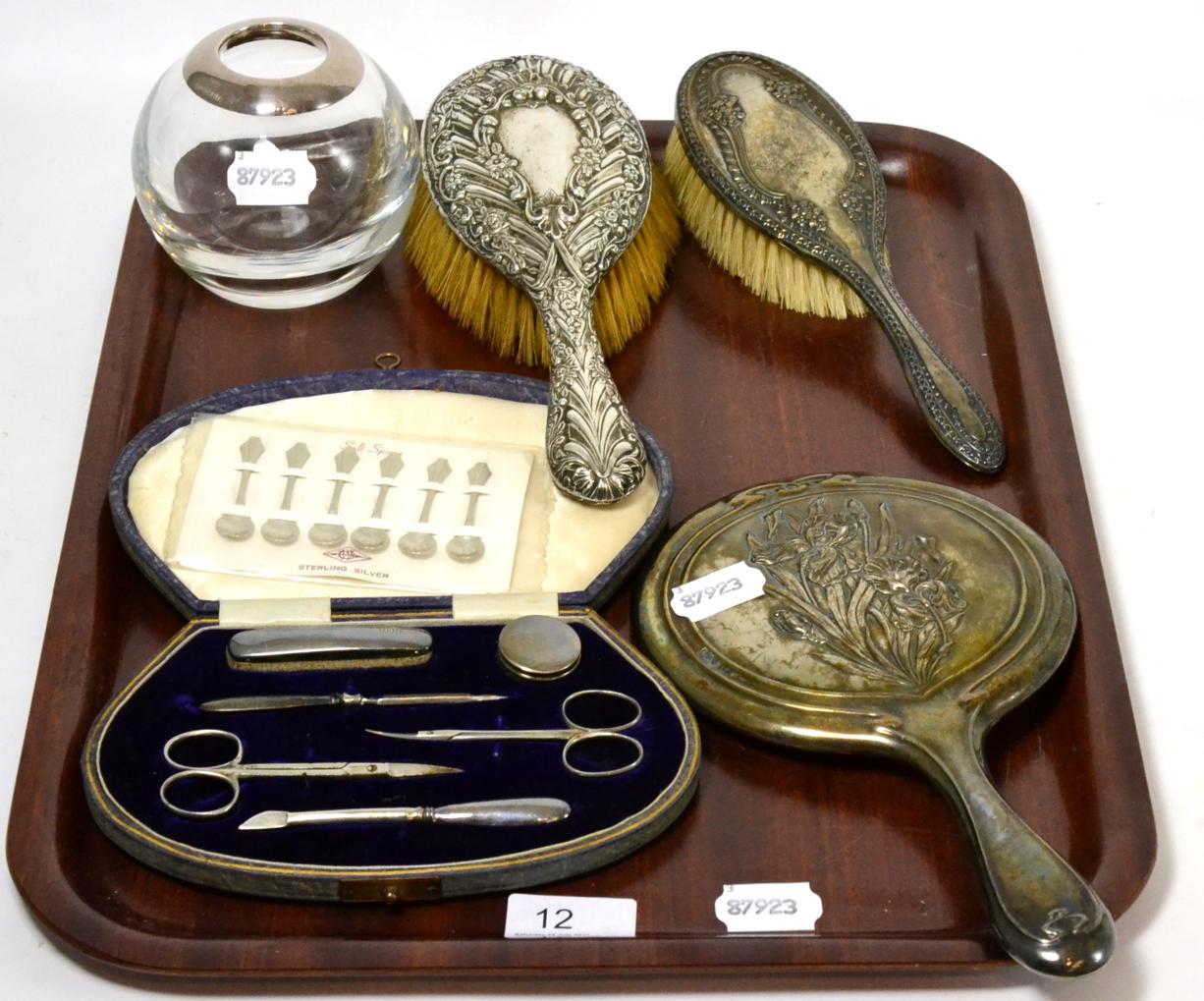 An Asprey & Co, London, silver mounted hair tidy toy with various silver backed dressing table items