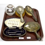 An Asprey & Co, London, silver mounted hair tidy toy with various silver backed dressing table items