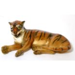 A Royal Doulton recumbent tiger, HN911Paint scratches and crazing.