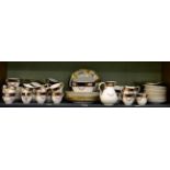 A quantity of gilt highlighted floral painted cobalt blue and cream tea wares including Coalport and
