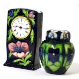 A Moorcroft anemone pattern clock and Violet pattern ginger jar and cover (2) Each piece with