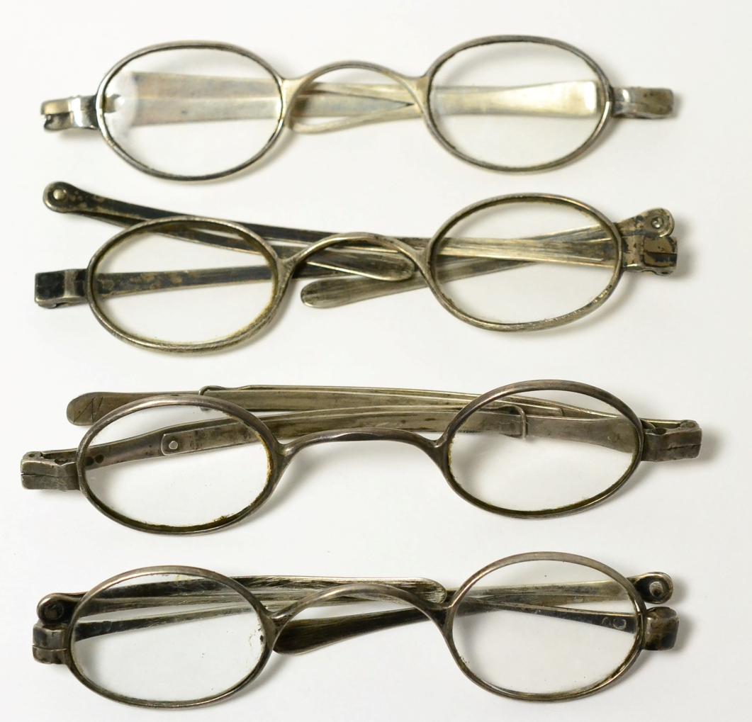 Four pairs of silver framed spectacles
