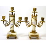 A pair of marble and gilt metal three light candelabra