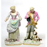 A pair of porcelain figures of a man and dog and a woman feeding birds with faux blue cross sword
