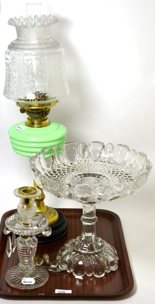 A Victorian oil lamp with green glass reservoir and etched glass shade, a glass lustre candlestick