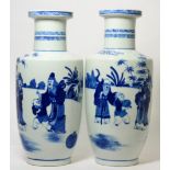 A near pair of Chinese blue and white porcelain rouleau vases Each with paint scratches and firing