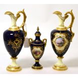 A pair of Coalport ewers painted with landscapes, and a similar vase and cover painted with