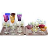 An assortment of coloured glassware including Harlequin set of six goblets etc