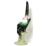 A large Tuscan china model of a magpie, modelled poised to eat a slug on a stump Appears in