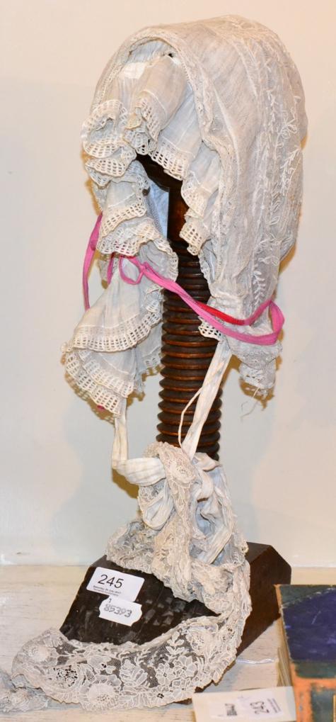 Wig stand with lace bonnets