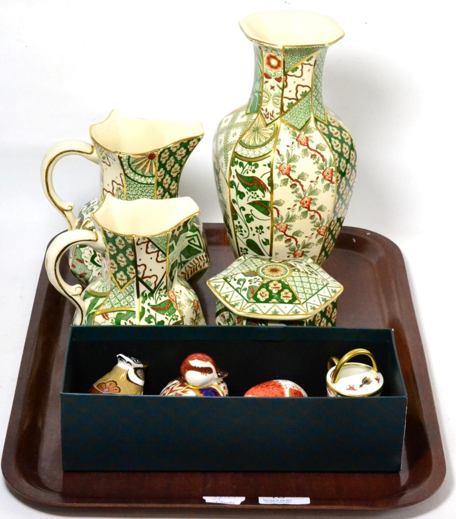 A group of three Royal Crown Derby Imari paperweights and a miniature watering can together with