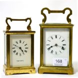 A brass carriage clock and a smaller similar timepiece