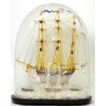 A Victorian glass frigger model of a ship under glass dome on ebonised plinth base