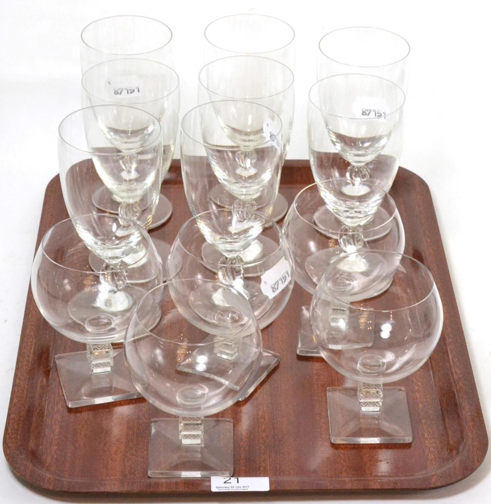 A set of eight Lalique wine glasses with wrythen stems and footed bases, together with five