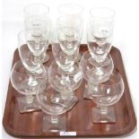 A set of eight Lalique wine glasses with wrythen stems and footed bases, together with five