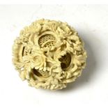 A late 19th/early 20th century Chinese ivory puzzle ball Diameter 7cm. One or two cracks to interior