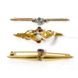 A 15ct gold opal and garnet bar brooch, a 9ct gold amethyst and diamond bar brooch and an aquamarine