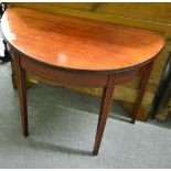 A George III line and chequered, string inlaid, demi-lune fold-over tea table