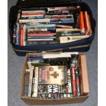 A quantity of military reference and history books in a suitcase and two boxes