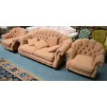 A buttoned hump back sofa with two matching armchairs (3)