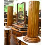 A pair of wlanut uniformly gadrooned cylindrical pedestals on stepped bases