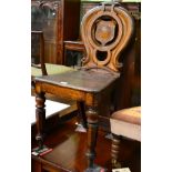 A Victorian oak, shield back plank seated chair