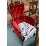 A Victorian carved mahogany framed button back armchair