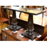 A pair of rosewood occasional tables each with tapering, faceted uprights