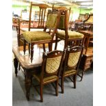 A Victorian carved oak wind out dining table and a set of six carved oak dining chairs