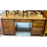 A leather inset pedestal desk