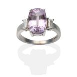 An 18 Carat White Gold Kunzite and Diamond Ring, an oval cut kunzite between baguette cut diamonds