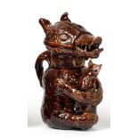 A Treacle Glaze Pottery Bear Jug and Cover, early 19th century, naturalistically modelled sitting