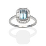 An Aquamarine and Diamond Ring, an octagonal cut aquamarine within a border of eight-cut and