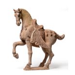 A Chinese Painted Pottery Model of a Horse, Tang Dynasty (618-906AD), the standing beast with one