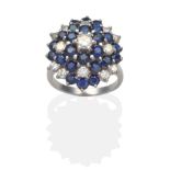 A Sapphire and Diamond Cluster Ring, a central round brilliant cut diamond within a graduated