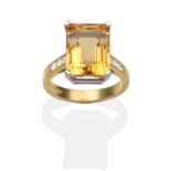 An 18 Carat Gold Citrine and Diamond Ring, an octagonal cut citrine in a white claw setting, to