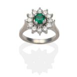 An Emerald and Diamond Cluster Ring, an octagonal cut emerald within a border of round brilliant cut
