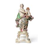 A Chelsea Porcelain Figure of Apollo, circa 1760, the loosely draped figure standing holding a lyre,