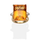 An 18 Carat Gold Citrine and Diamond Ring, an octagonal cut citrine in a yellow claw setting, to