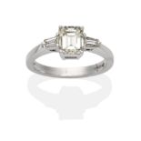 A Platinum Diamond Solitaire Ring, an octagonal cut diamond between tapered baguette cut diamonds in