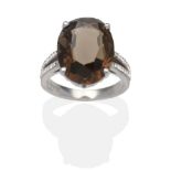 An 18 Carat White Gold Smokey Quartz and Diamond Ring, an oval cut smokey quartz in a claw setting