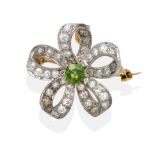 A Demantoid Garnet and Diamond Scroll Brooch/Pendant, a round cut demantoid garnet in a white claw