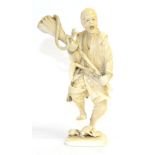 A Japanese Ivory Okimono, Meiji period, as a farmer holding a brush containing a snake, two toads at