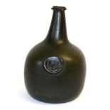 A Green Glass Sealed Wine Bottle, 18th century, of onion shape, the seal with a lion passant, 19cm