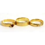 Two 22ct gold rings and an 18ct gold band ring Two 22ct gold rings - finger size N and M, 7.8g